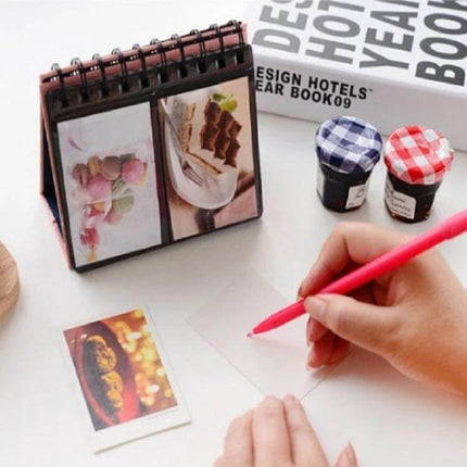 Calendar Style Desktop Standing Folder Album 68 Photos on desk showing vertical photo display with guest photos and small jars