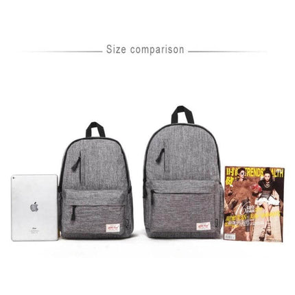 Canvas Laptop Backpack For 15.6 Inch Laptops Commuter Pack showing two gray backpacks side-by-side with tablet and magazine for size comparison