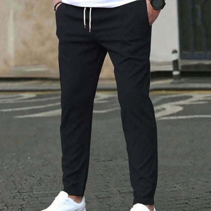 Casual Cropped Straight Pants For Leisure In Solid Black modeled with white sneakers and drawstring waist for everyday casual wear