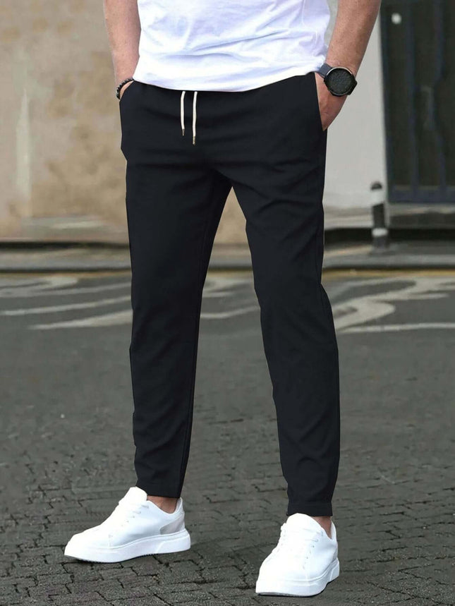 Casual Cropped Straight Pants For Leisure In Solid Black modeled with white sneakers and drawstring waist for everyday casual wear