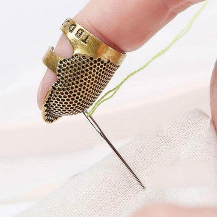 Sewing Thimble Finger Protector for Everyday Sewing Small copper thumb protector guiding needle through fabric