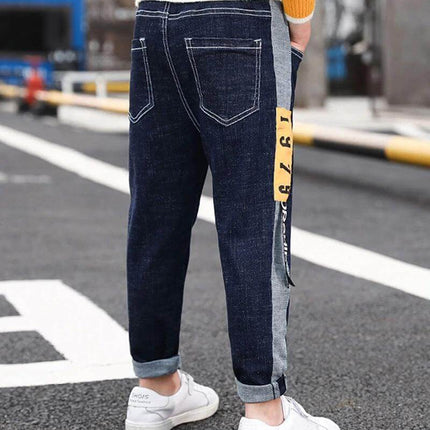 CUHK Kids' Fashion Straight Casual Pants Dark Blue - back view of child wearing lightweight cotton straight-leg casual pants with side stripe and rolled cuffs