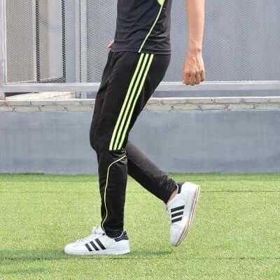 Dema Men's Straight Leg Leisure Pants for Running and Casual Wear - black straight-leg polyester running pants with neon stripe, model walking