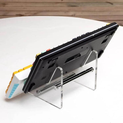Detachable Keyboard Stand for Everyday Desk Setup at Home showing clear acrylic stand holding a compact keyboard on a small desk