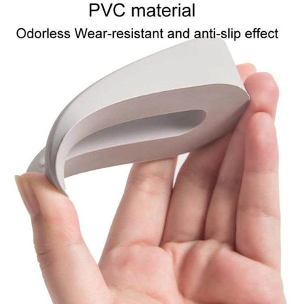 Donut Door Stopper Hole-Free For Quiet Home Protection - gray PVC adhesive donut door stopper held in hand, non-marking anti-slip design