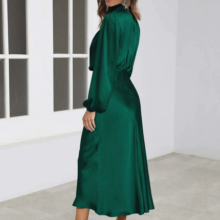 Satin Halterneck Mid Length Dress With Long Sleeves For Evening in emerald satin with halter neckline, lantern sleeves and stitched patchwork skirt