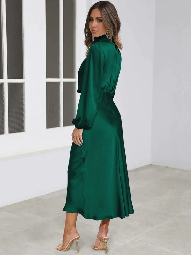 Satin Halterneck Mid Length Dress With Long Sleeves For Evening in emerald satin with halter neckline, lantern sleeves and stitched patchwork skirt