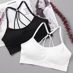 Two wireless nylon tube top bras for girls in black and white, stylish and comfortable, displayed on a grey background with a magazine.