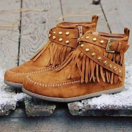 Retro Suede Ankle Boots With Tassel Rivet Flat Winter Wear in tan suede with tassels, rivet strap and side zipper on icy city pavement