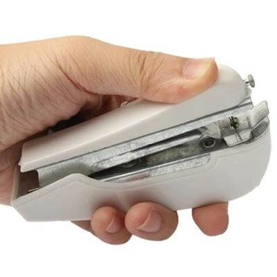 Handheld Mini Sewing Machine For Quick Hem Repairs On The Go compact white handheld device shown in hand for travel and on-the-spot alterations