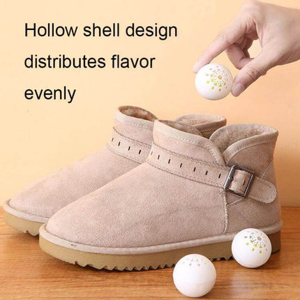 Hollow Ball Shoe Cabinet Deodorant Freshener For Shoes And Home showing hollow ball placed near boots to freshen confined spaces