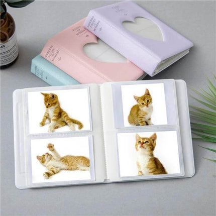 Hollow Heart 64 Pockets Photo Album for Instax Mini Sky Blue - compact sky blue PVC album with hollow heart cover and 64 pockets shown open with Instax photos