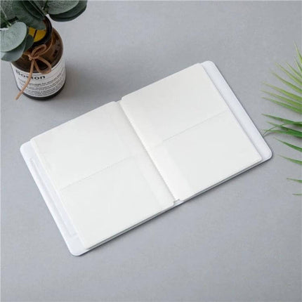 Hollow Heart 64 Pockets Photo Album for Instax Mini Sky Blue - open compact album showing blank Instax Mini pockets on gray background
