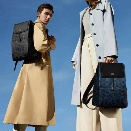 Huawei Style Laptop Backpack For Everyday Use Size L carried by male and female models in trench coats against blue sky, 15.6" laptop compartment protected