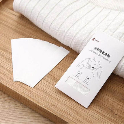 Invisible Anti-Slip Shirt Straps For Secure Wear, 85x18mm clear PET adhesive strips next to white knit top to prevent slipping