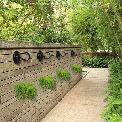 Iron Ceiling Hooks 4 Pack For Hanging Flower Baskets - black iron wall-mounted hooks holding hanging planters on outdoor patio