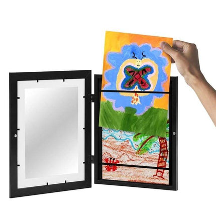 Kids Magnetic Front-Opening Art Frame For Photos And Drawings showing hand inserting colorful kids drawing into black magnetic front-opening wood and plastic display frame