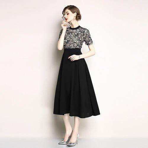 Lace Short Sleeve Mid Length Swing Dress for Everyday Casual Wear in black with geometric embroidered lace bodice and flowing swing skirt