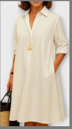 Ladies Long Sleeve Mid-Length Shirt Dress In Solid Colors in cream cotton-poly blend with POLO collar, pockets, rolled sleeves styled with pendant