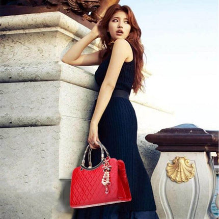 Large Capacity PU Leather Handbag For Everyday Use - red quilted tote held by model in black dress, multiple compartments, polyester lining
