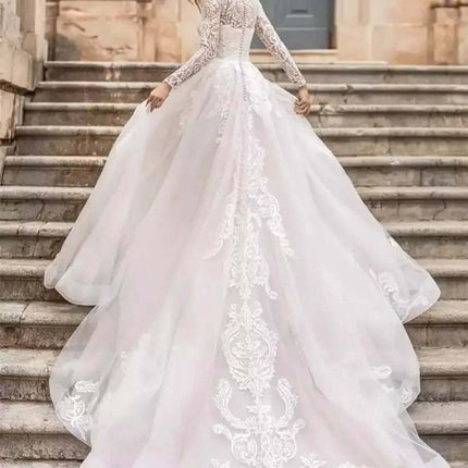 Long Sleeve Wedding Dress With High Waist For Brides in ivory polyester with lace bodice, princess long sleeves and flowing train for a church wedding