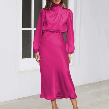 Satin Halterneck Mid Length Dress With Long Sleeves For Evening in fuchsia matte satin with halter neckline, lantern sleeves and stitched patchwork skirt