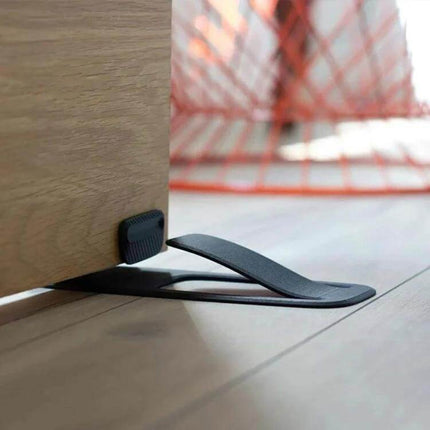 Spring Door Stopper Keeps Doors Open For Homes And Offices - matte black spring-loaded plastic door stop preventing slams and allowing hands-free passage