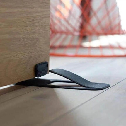 Spring Door Stopper Keeps Doors Open For Homes And Offices - matte plastic spring-loaded stopper preventing door slams and allowing hands-free passage