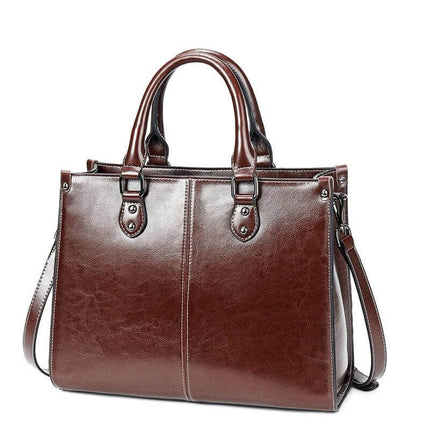 Oil Wax Leather Sling Handbag For Everyday Shoulder Use - brown oil-waxed cowhide sling with top handles and adjustable shoulder strap, compact structured design
