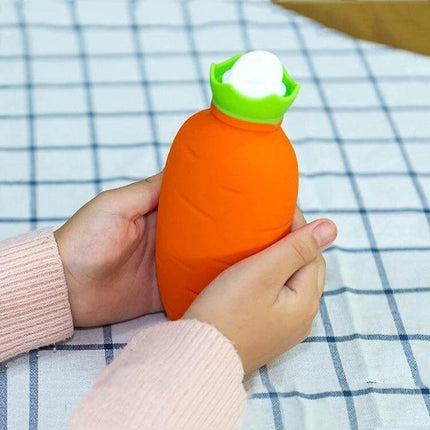Orange Carrot-Shaped Silicone Water Bag Hand Warmer held in hands, 330ml carrot-shaped hot or cold silicone water bag