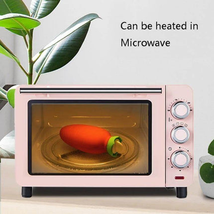 Orange Carrot-Shaped Silicone Water Bag Hand Warmer shown inside microwave to illustrate heating option - 330ml carrot-shaped silicone hand warmer