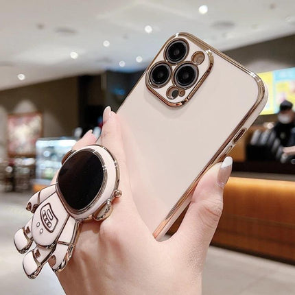 Astronaut Phone Case With Stand For Hands-Free Viewing showing rose gold ultra-thin case with 3D folding astronaut stand in a cafe