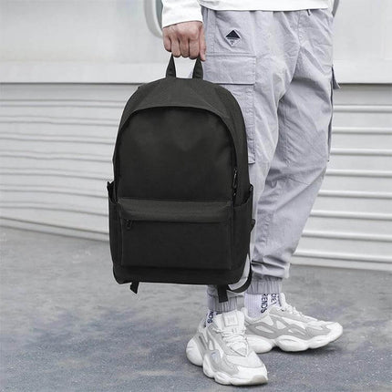 Oxford Laptop Backpack for Work, Study, and Travel - black oxford fabric backpack held by hand, tear- and water-repellent, multi-compartment for laptop and daily essentials