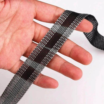 Pant Leg Stickers For Repairs 50m Polyester Roll For DIY Patches - close-up hand holding grey patterned iron-on fabric tape roll for hemming and repairs