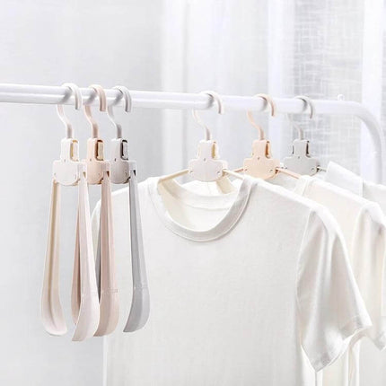 Plastic Travel Folding Clothes Hanger With Wide Shoulders hanging compactly on a rail, unfolded for drying shirts and folded for travel