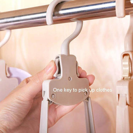 Plastic Travel Folding Clothes Hanger With Wide Shoulders hanging on rod, folded compact beige PP plastic travel hanger showing one-key clip