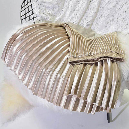 Pleated Satin Skirt, High Waist For Spring And Summer in glossy champagne gold pleated fabric laid flat with stitched folds