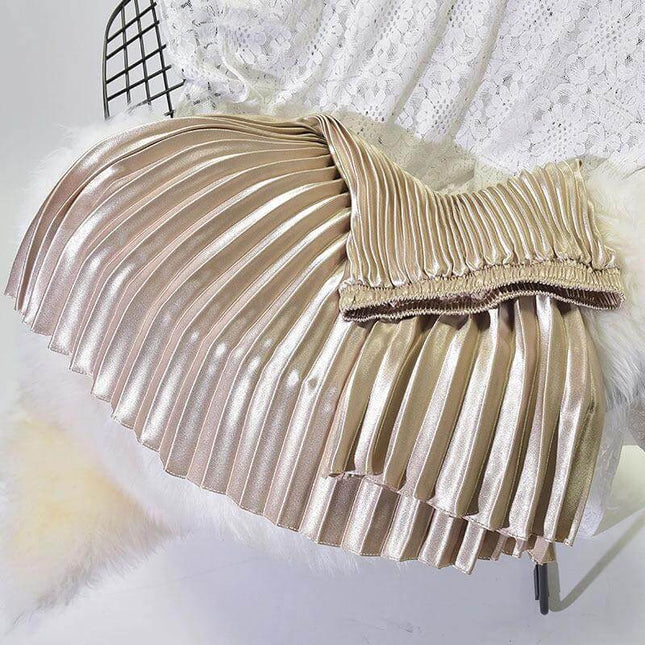 Pleated Satin Skirt, High Waist For Spring And Summer in glossy champagne gold pleated fabric laid flat with stitched folds