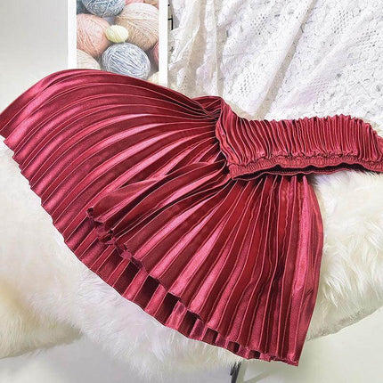 Pleated Satin Skirt, High Waist For Spring And Summer - glossy red pleated satin high-waist skirt laid flat showing stitched folds and elastic waistband