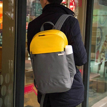 POFOKO XY Series 14-15.4 Inch Laptop Backpack for Everyday Use - grey and yellow commuter backpack shown on person with water bottle