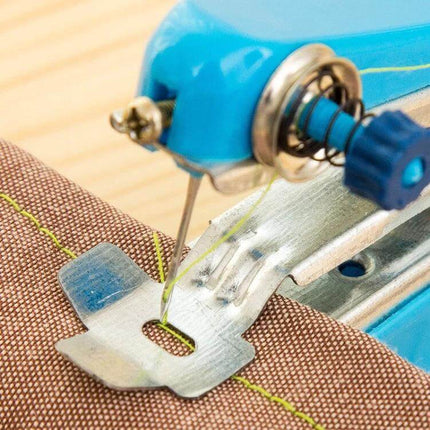 Portable Mini Handheld Sewing Machine 11x7 Cm For Quick Repairs close-up stitching on fabric, compact blue handheld sewing tool