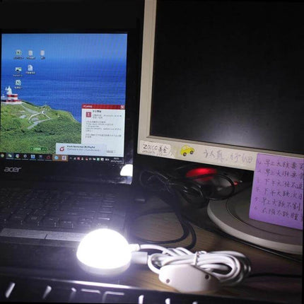 Portable USB Reading Light With Magnetic Base Warm White clipped to laptop and illuminating keyboard with warm glow