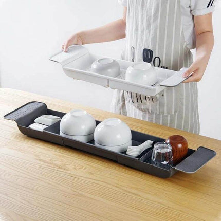 Retractable Bathtub Shelf Rack Adjustable White Gray holding bowls, utensils and cups over sink with ventilated base for drying and storage