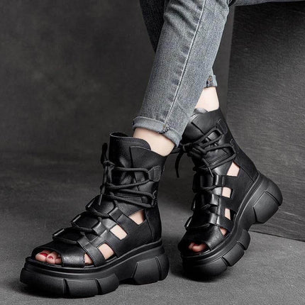 Roman Inspired Open Toe PU Ankle Boots For Women Black on model wearing cropped jeans, city-commute style open-toe sandal-boot with chunky sole