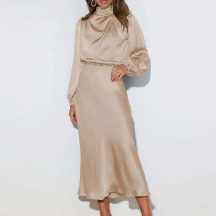 Satin Halterneck Mid Length Dress With Long Sleeves For Evening in champagne satin with halter neckline, lantern sleeves and stitched patchwork skirt