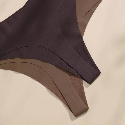 Seamless Wirefree Bra And Low Waist Thong Set In Ice Silk laid flat showing three neutral-tone seamless low waist thongs and bra set