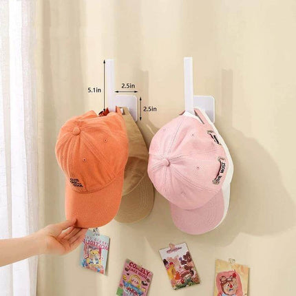 Baseball Hat Wall Hook Self-Adhesive 2-Pack Black/White showing two self-adhesive hooks holding caps on a wall, easy tool-free installation