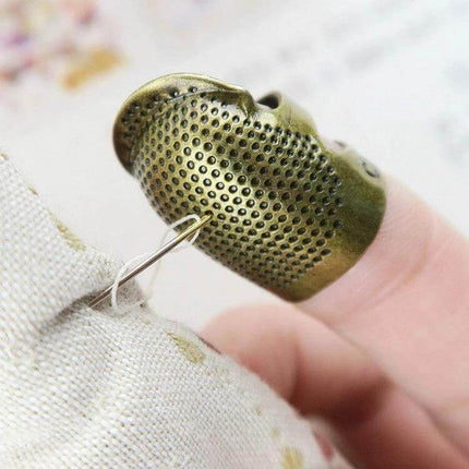 Sewing Thimble Finger Protector for Everyday Sewing Small copper thimble protecting fingertip while hand sewing with needle