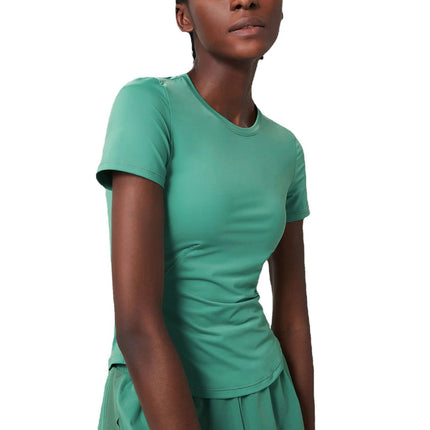 Small Waist Yoga Top With Short Sleeves In Black For Studio Practice modeled in green short-sleeve nylon training shirt paired with high-waist shorts