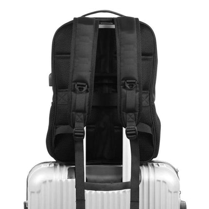 Solar Panel Backpack For Laptop With USB Charging Port shown strapped to suitcase handle, padded straps and luggage sleeve visible